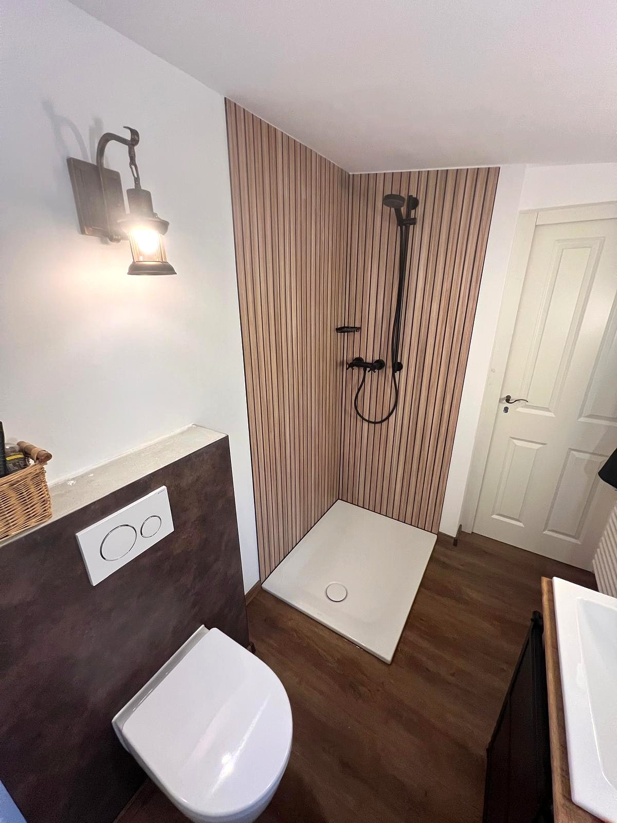 Bad mit Holzlamellen-Duschrückwand, Duschwanne, Wand-WC und Boden in Holzoptik
